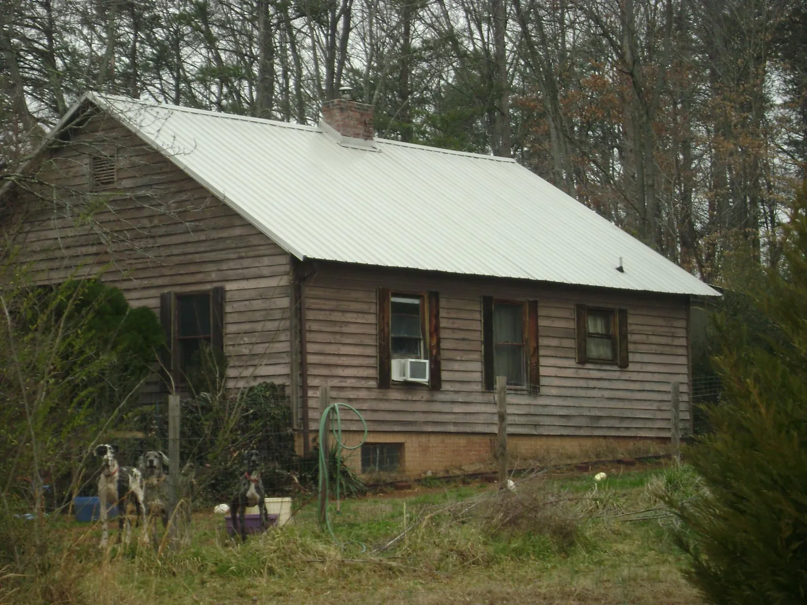 White metal roof on an old wood sided farmhouse, from a Asphalt Shingle Roof Repair job in Aberdeen